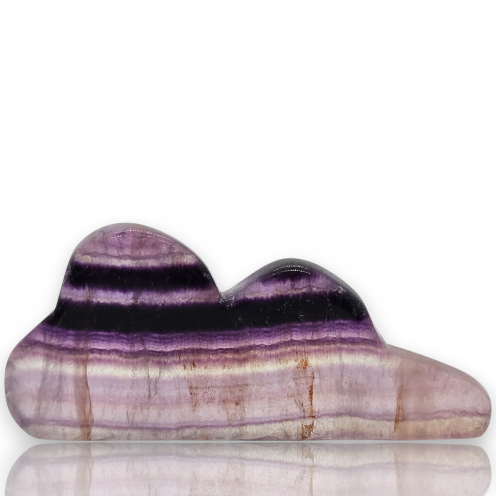 A polished cat-shaped stone with horizontal purple, black, and beige banding, displayed on a white background 