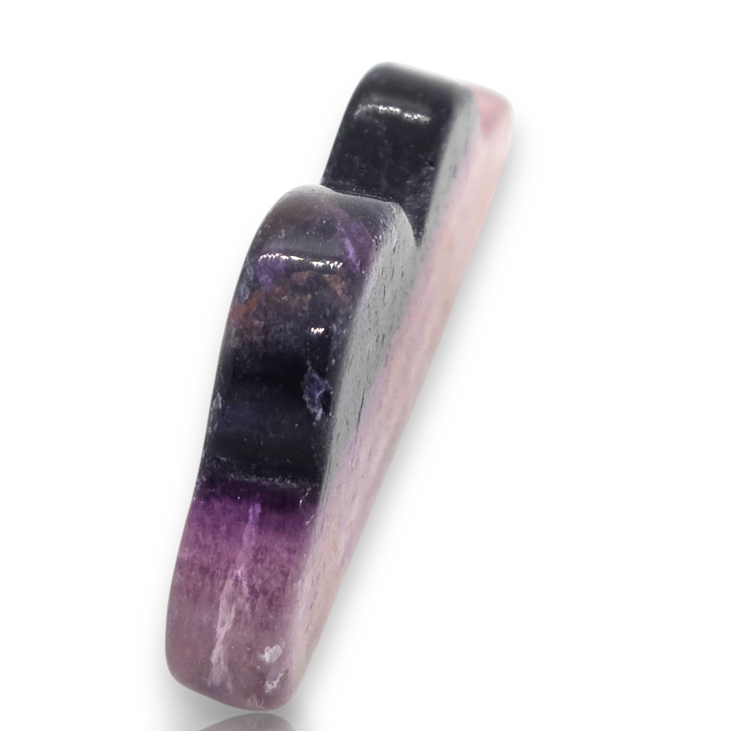 A polished gemstone cabochon with a distinct color transition from deep purple to pink, displayed on a clean white background