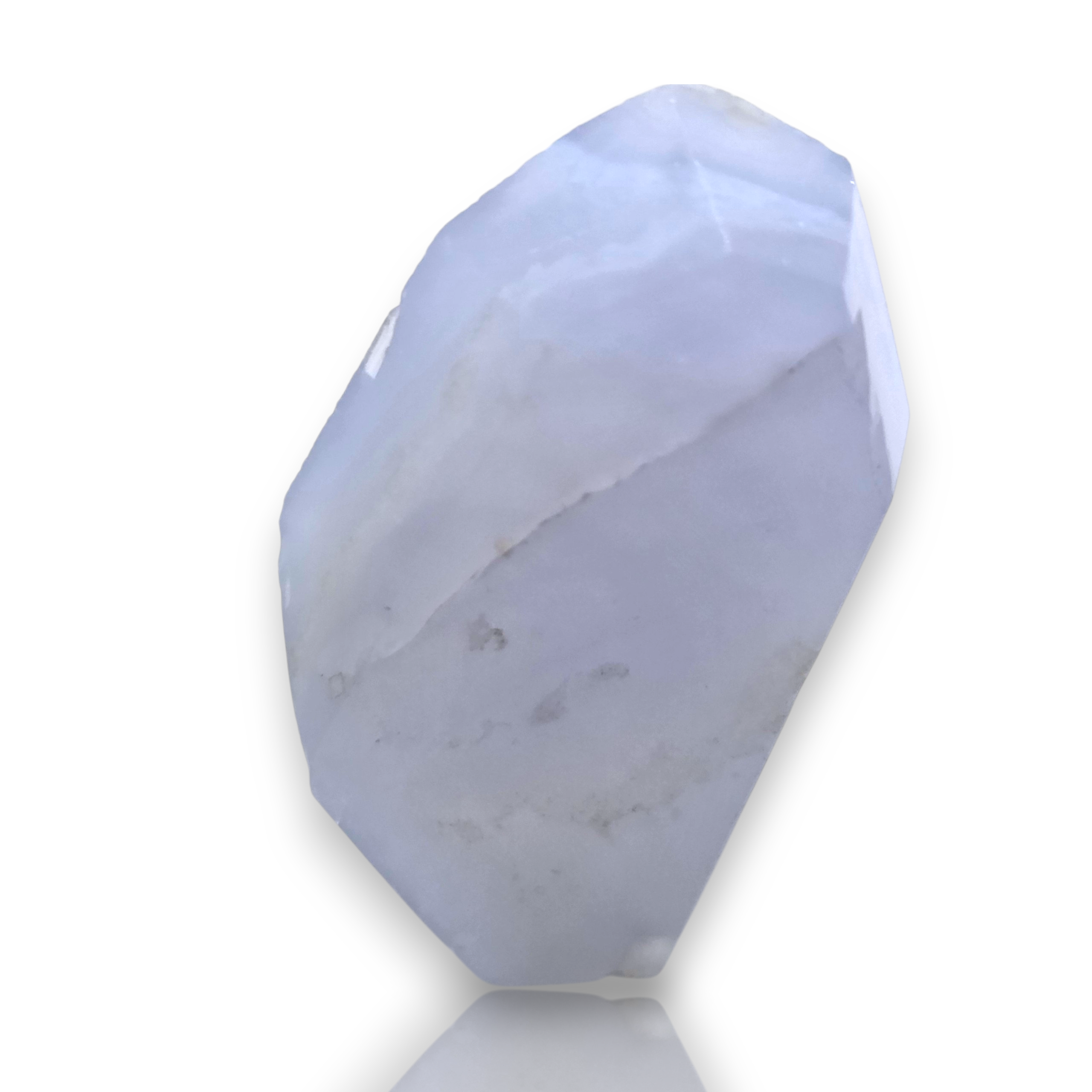 A faceted white crystal stone with subtle gray and pale blue marbling, displayed on a clean white background with a soft reflection. 
