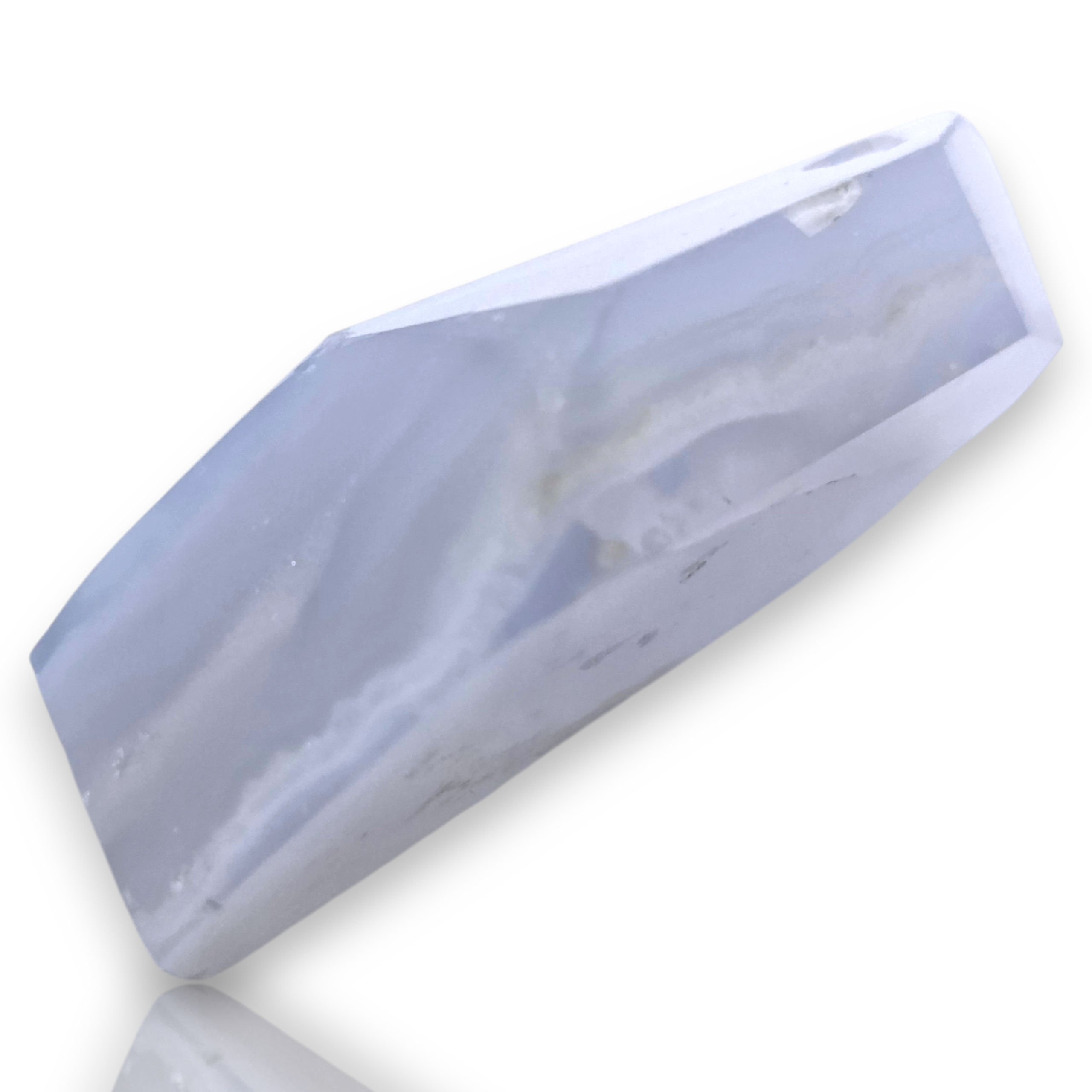 A faceted pale blue-gray crystal or stone sample shown on a clean white background