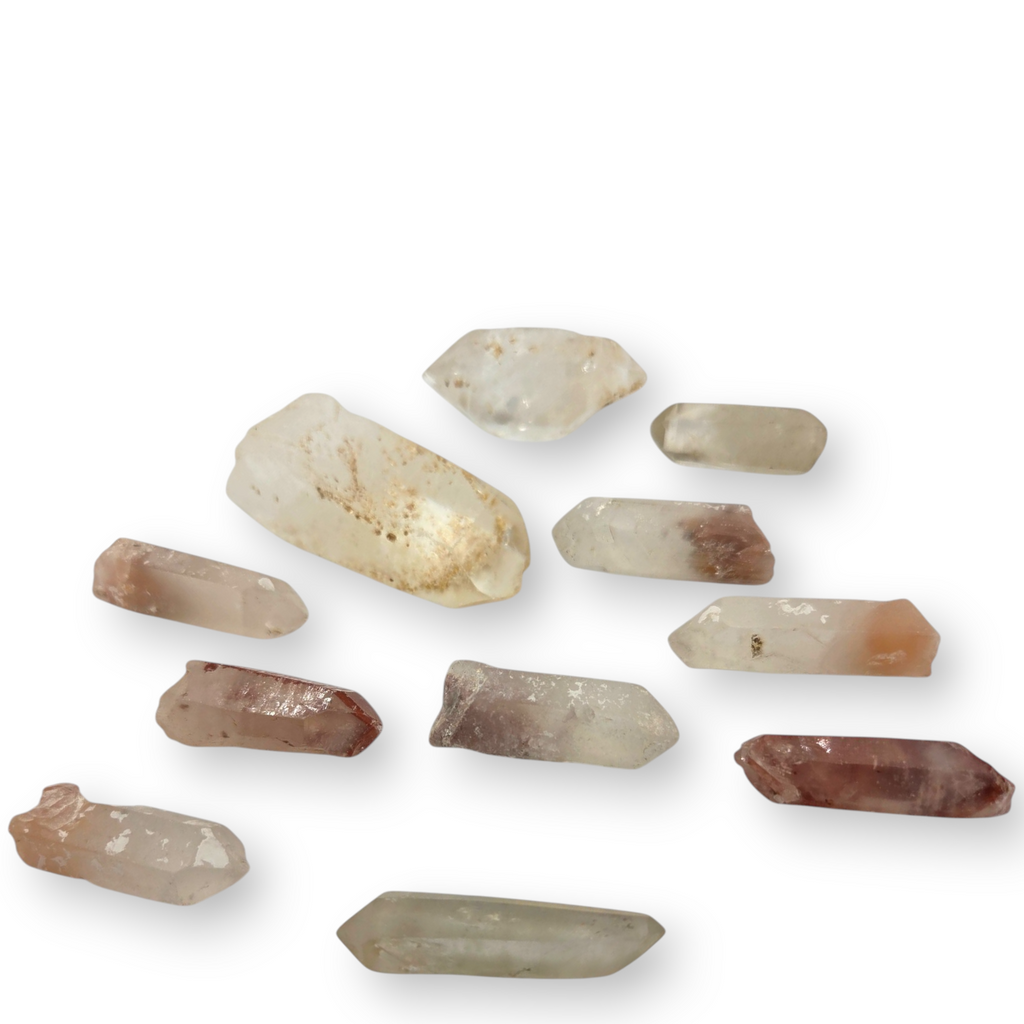 Crystal Chrysalis Haus A set of nine raw crystal points in various natural colors and shapes, arranged on a white background 