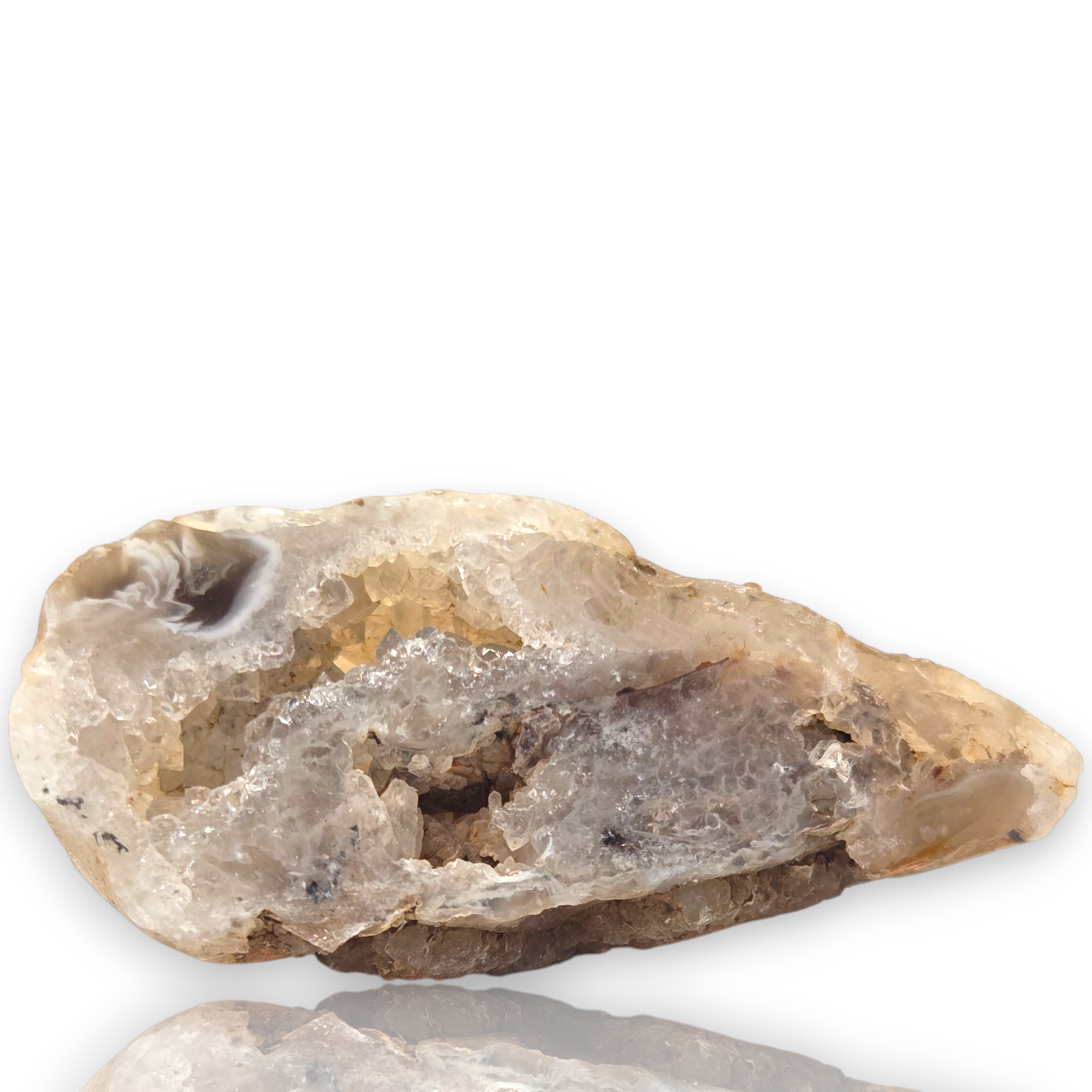 Crystal Chrysalis Haus  A raw crystal geode specimen with a translucent white and gray druzy structure, photographed on a clean white background 