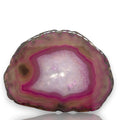 Crystal Chrysalis Haus A polished slice of agate or jasper stone with concentric bands of pink, magenta, purple, and brown around a pale lavender to white crystalline center, shown on a white background with a faint reflection below.