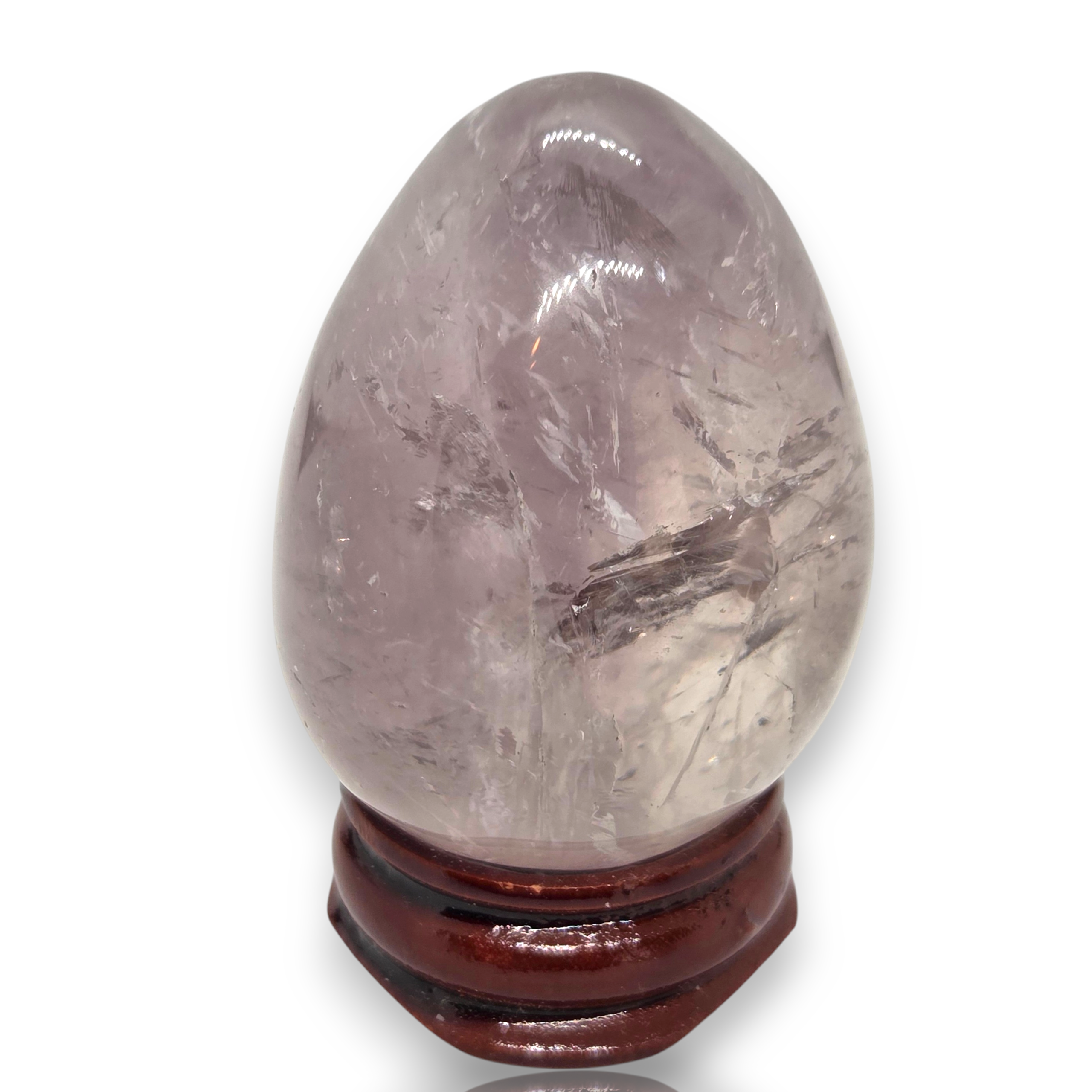 Crystal Chrysalis Haus A polished lavender-gray quartz crystal egg on a dark reddish-brown wooden display stand, shown against a plain white background