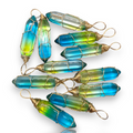 Crystal Chrysalis Haus Nine blue and green gradient crystal point pendants with gold wire wrapping, arranged on a clean white background.