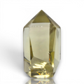 Crystal Chrysalis Haus A faceted point crystal gemstone with a pale yellow-green hue, displayed on a clean white background 
