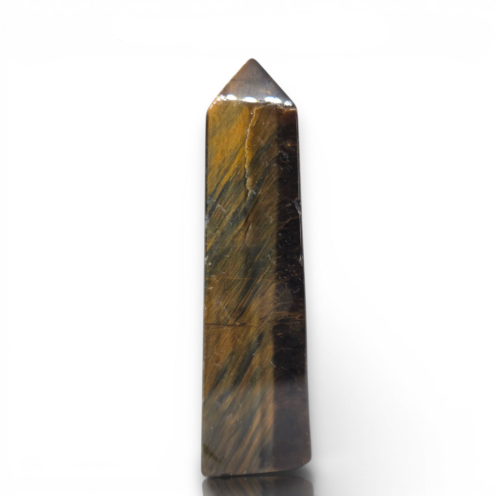 Crystal Chrysalis Haus A polished tiger's eye crystal point wand with natural brown and gold banded striations, standing vertically on a white reflective surface.