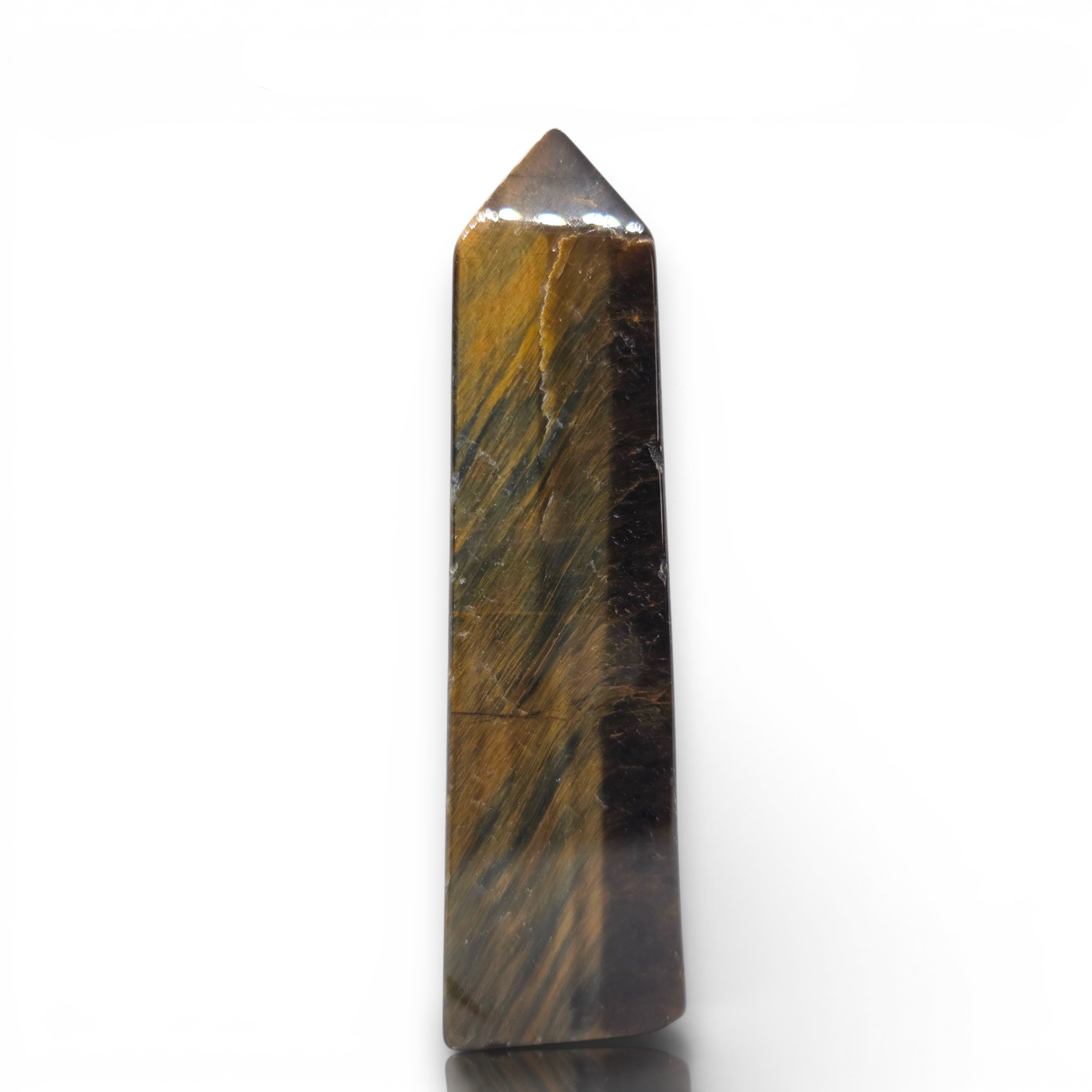 Crystal Chrysalis Haus A polished tiger's eye crystal point wand with natural brown and gold banded striations, standing vertically on a white reflective surface.