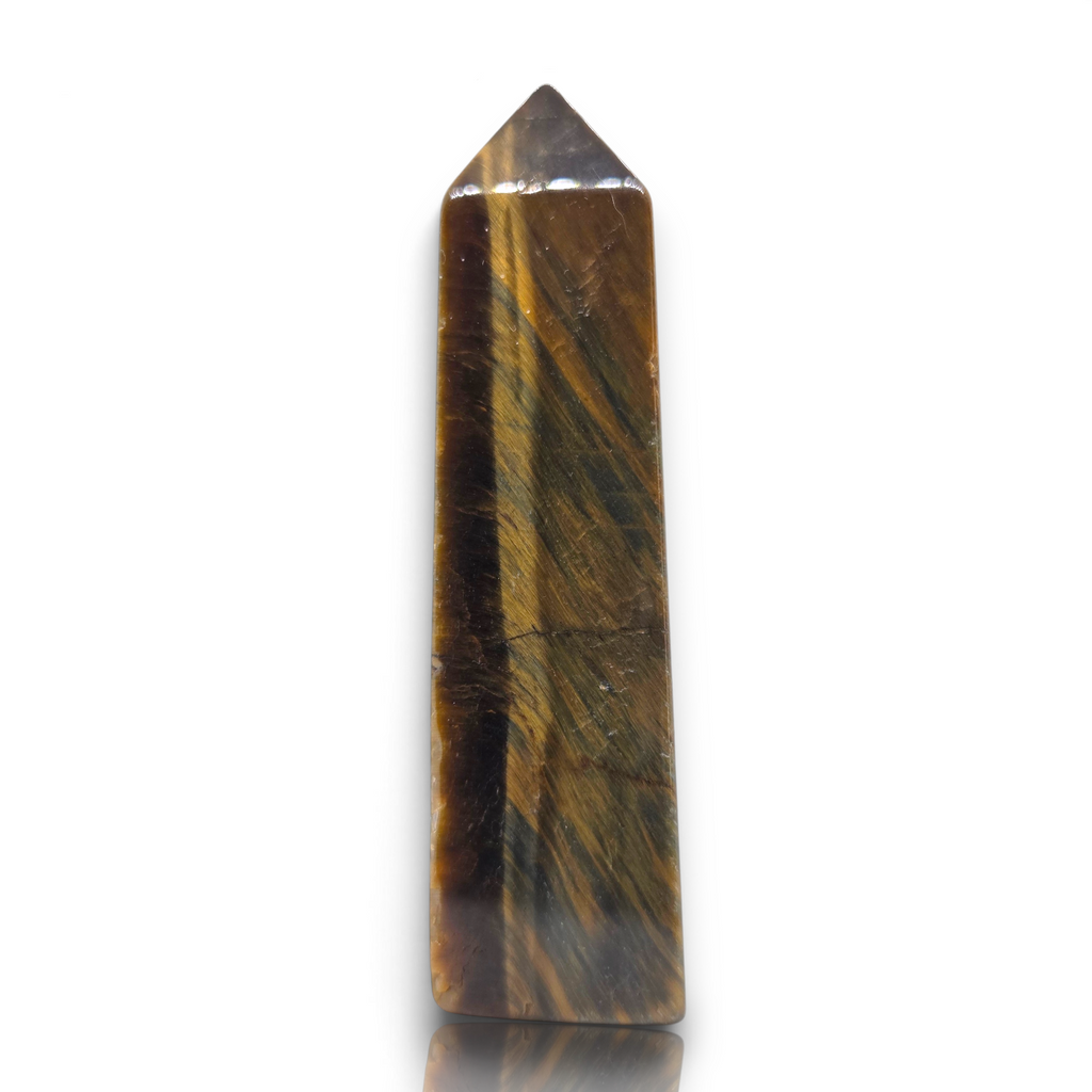 Crystal Chrysalis Haus A polished tiger's eye crystal tower with natural brown and gold banded stripes, standing upright on a reflective white surface against a white background.