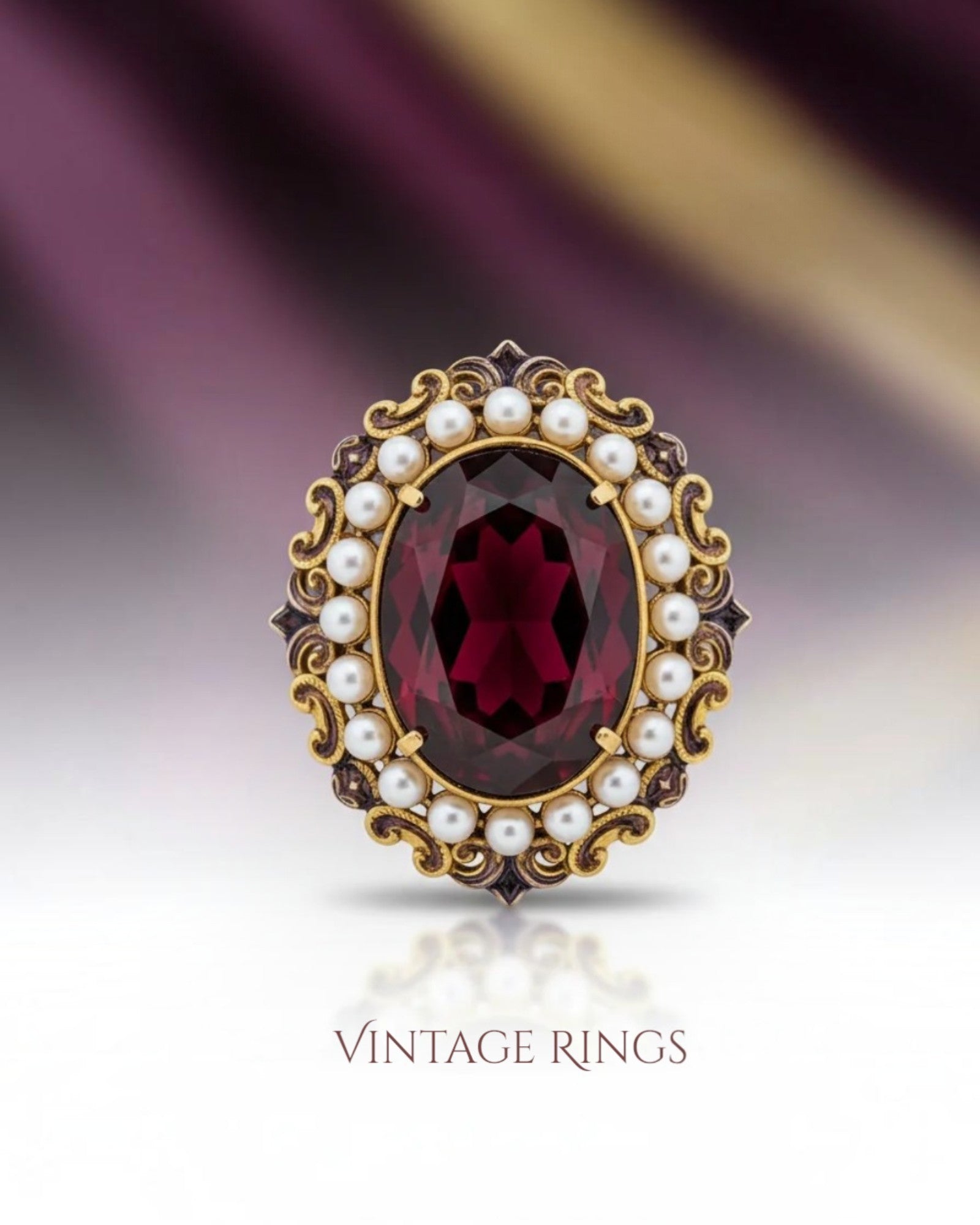 Crystal Chrysalis Haus An ornate vintage ring featuring a large oval faceted dark red gemstone surrounded by a halo of white pearls and gold filigree, set against a dark purple and gold background with the text 'VINTAGE RINGS' below.