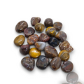 Crystal Chrysalis Haus A pile of polished tumbled gemstone chips in earthy brown, gold, gray, and purple tones, arranged on a plain white background.