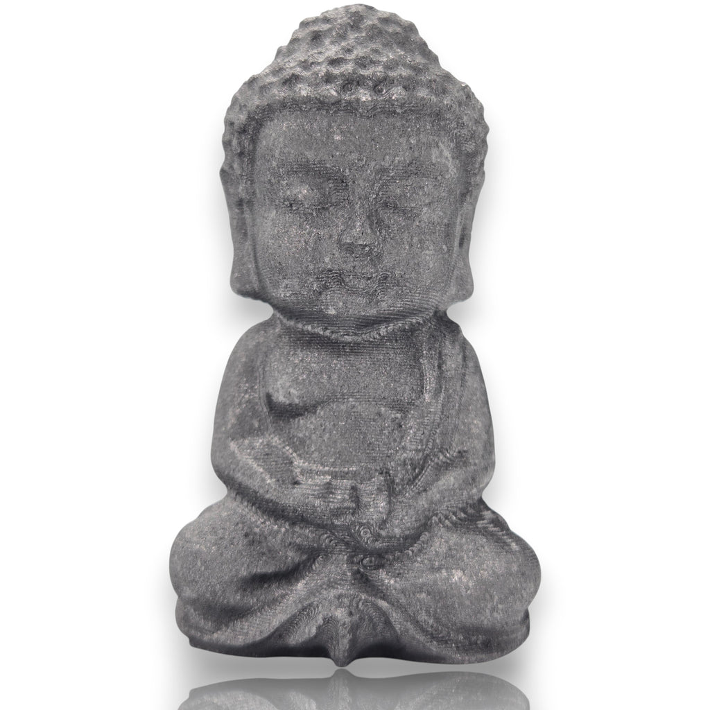 Crystal Chrysalis Haus A small gray stone Buddha statue in a seated meditation pose, centered on a white background with a subtle reflection below.