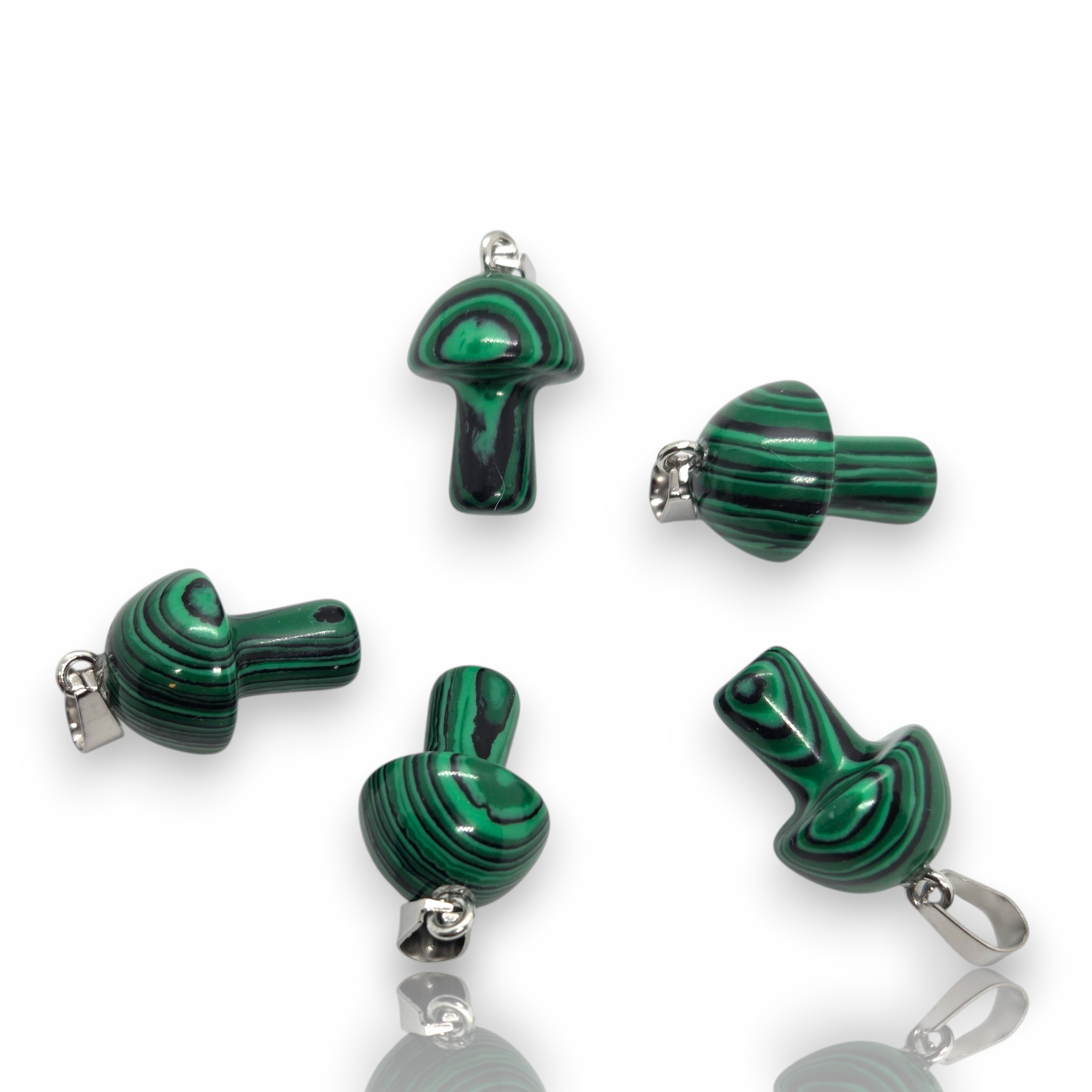Crystal Chrysalis Haus Five green malachite pendant charms with silver-tone loops, arranged on a clean white background with subtle reflections.