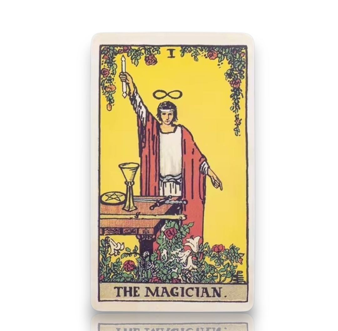 A tarot card product shown on a white background. The card depicts 'The Magician' with a yellow background, a robed figure holding a candle, and decorative floral elements.