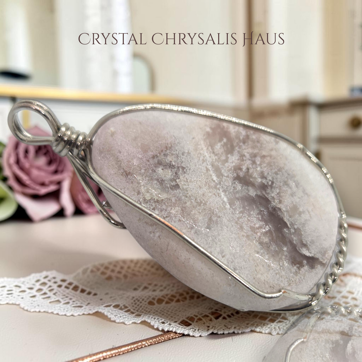 Crystal Chrysalis Haus hand crafted pear-shaped natural pink opal pendant wrapped in decorative silver wire wrap pendant