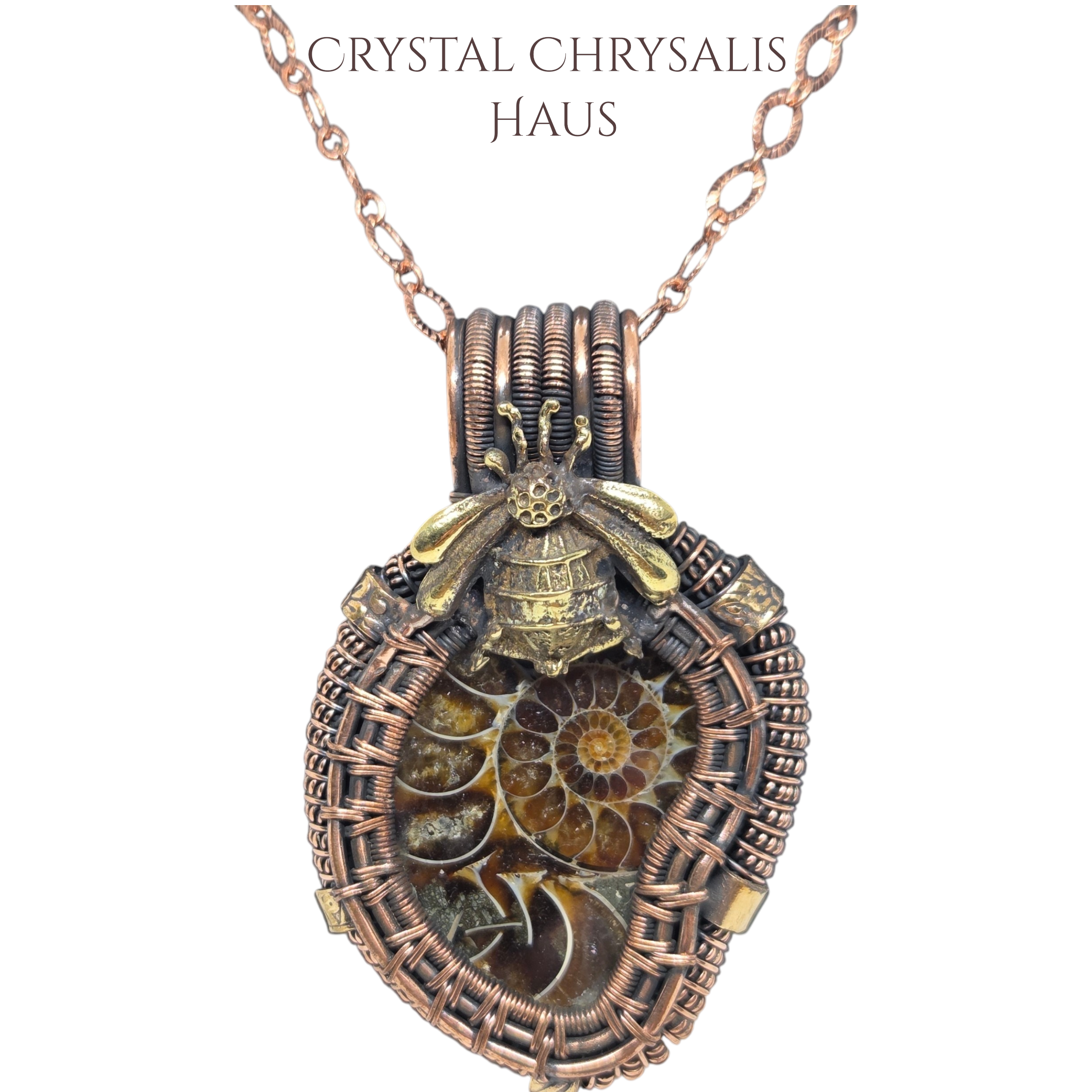 A detailed crystal chrysalis pendant necklace featuring a fossilized ammonite shell inside a copper-wrapped cage with a gold bee accent, shown on a white background with the text 'CRYSTAL CHRYSALIS HAUS' at the top.
