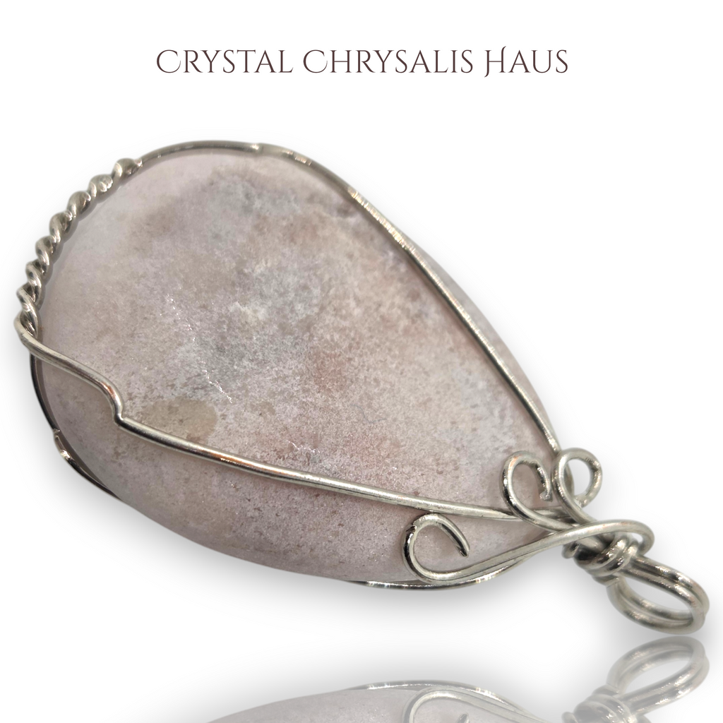 Crystal Chrysalis Haus hand crafted pear-shaped pink opal pendant wrapped in decorative silver wire wrap pendant