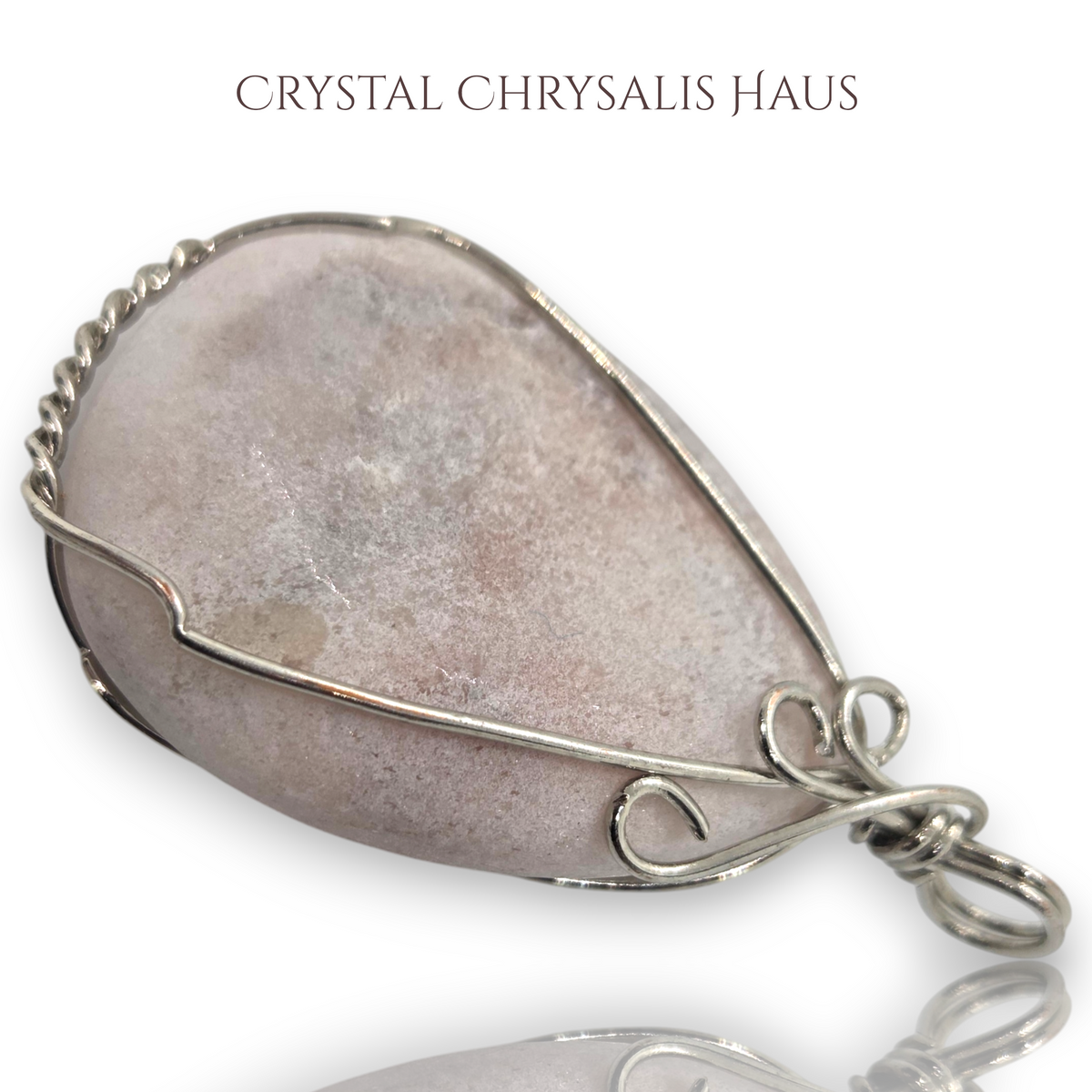 Crystal Chrysalis Haus hand crafted pear-shaped pink opal pendant wrapped in decorative silver wire wrap pendant